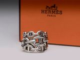 a close up of a silver ring with a box in the background
