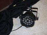 a black light that is on the floor next to a black bag