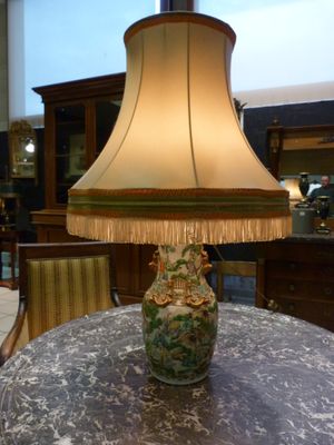 a lamp that is sitting on a table in a room
