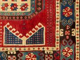 a red, blue and black rug with geometric design