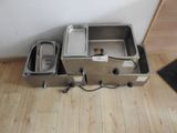 two stainless steel pans sitting on the floor next to each other
