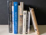 many books that are sitting on a shelf next to each other