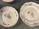 three plates with flowers on them on a table