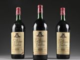 three bottles of wine sitting on top of a table next to each other