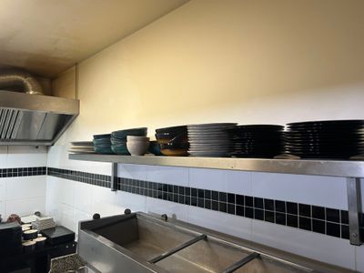 a kitchen with a lot of dishes on the shelves