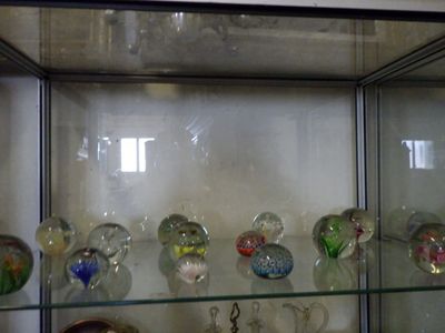 many glass vases on display in a glass case