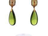 a pair of green and gold earrings with a green tear