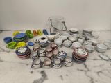 a lot of dishes and cups on the table