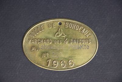 an old brass plate with the name of a man on it