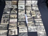 a lot of old black and white pictures on the table