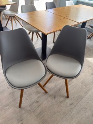 two chairs sitting at a table in the middle of a room