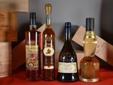 several bottles of wine are lined up on a red table