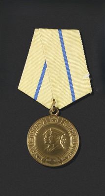 a gold medal with a blue and white ribbon around it