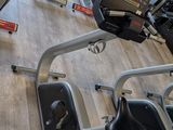 a gym room with a row of stationary exercise bikes