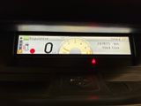 a car dashboard with a speedometer and a clock on it