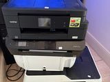 a stack of printers sitting on top of each other on the floor