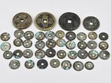 several different types of coins are arranged on a white surface