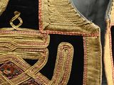 an image of a gold and black vest on display