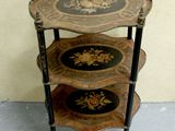 a three tiered table with a decorative design on it