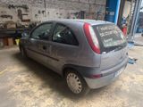 une petite voiture garée dans un garage, avec une pancarte à l'arrière