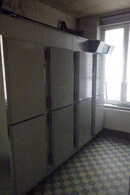 an image of a kitchen with a checkered floor and refrigerators