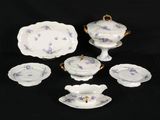 five pieces of china on a black background