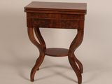 a small wooden table with a drawer on top of it