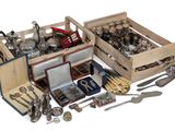 many different types of silverware in a wooden box