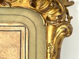 a gold frame with a picture of a man and a woman