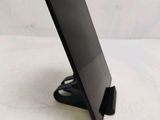 a tablet computer sitting on a stand on a table