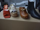 several pairs of shoes are lined up on a cardboard box