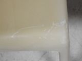 a close up of a white plastic chair with white paint on it