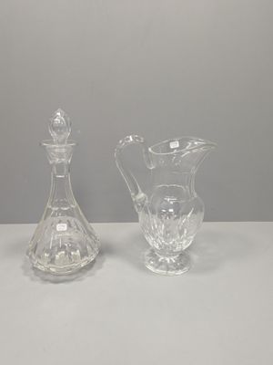 two clear glass vases sitting on top of a white table
