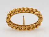 an 18k gold ring with a twisted rope design