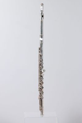 a close up of a flute on a stand on a white surface