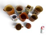 many different types of coffee mugs on the table