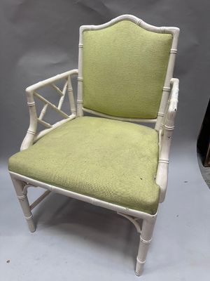 a white chair with a green upholstered seat