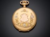 a gold pocket watch with a picture of a woman on it