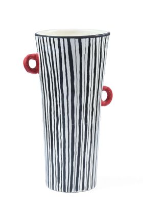 striped black and white vase with red handles on a white background