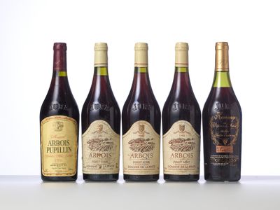 four bottles of wine are lined up on a table