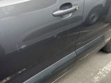 a car that has been damaged and is parked on the side of the road