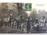 an old photo of a group of people with dogs and horses