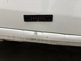 a sticker on the back of a white car