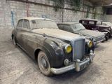 many old cars that are parked in a garage