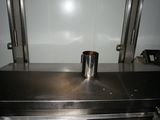 a large stainless steel oven with a metal container on top of it