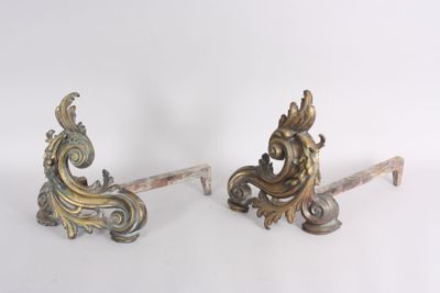 two ornate metal brackets on a white surface