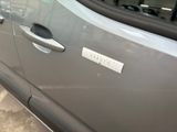 a silver car with a sticker on the side of it ' s door