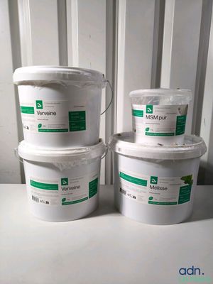 three buckets of white paint sitting next to each other on a table