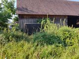 a barn that is in the middle of a field