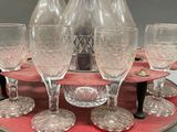bottles and glasses on a tray on a table with a red cloth